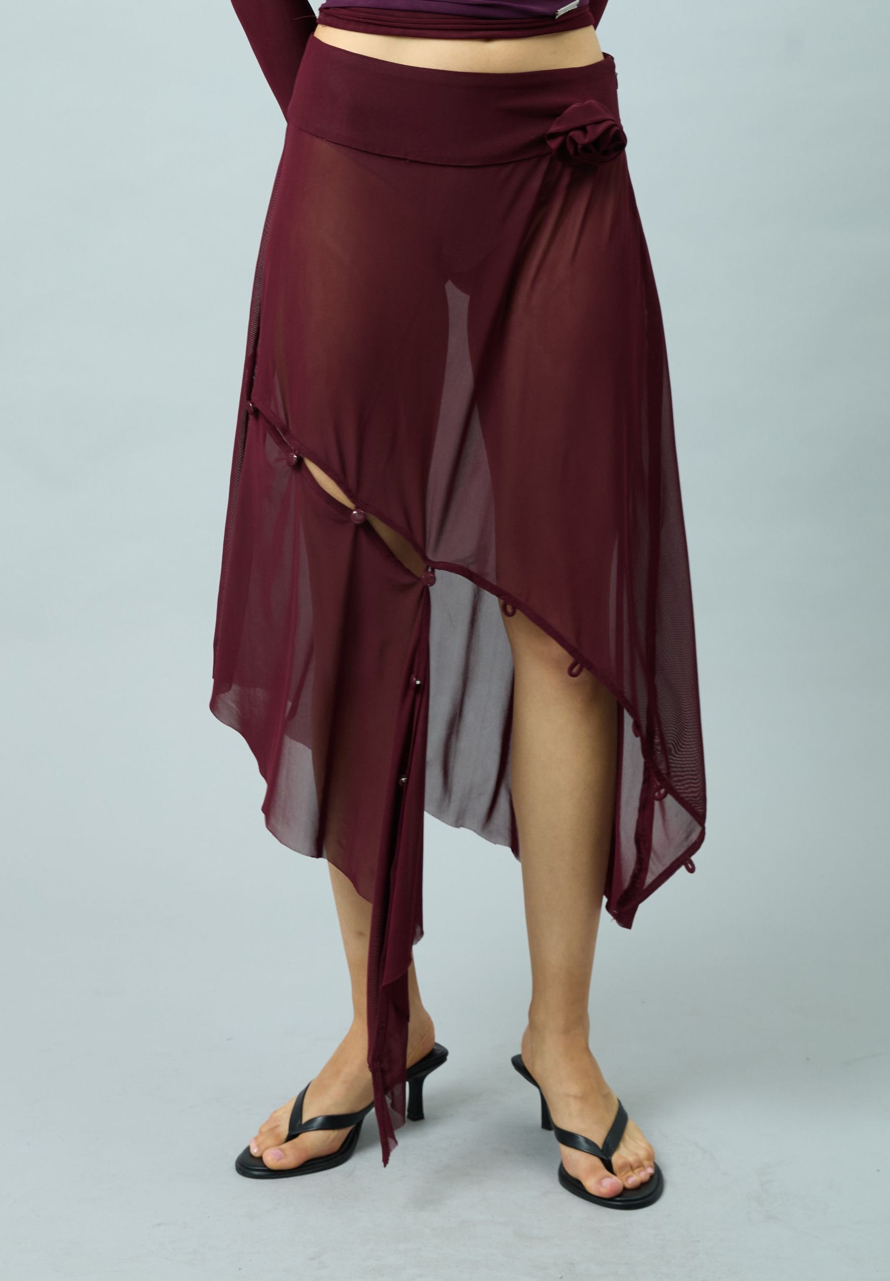 ASYMMETRIC MESH SKIRT WITH FLOWER APPLIQUE